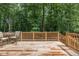Spacious wooden back deck overlooking a lush, wooded backyard, ideal for outdoor relaxation at 711 Kentcie Ln, Efland, NC 27243