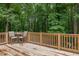Spacious wooden back deck overlooking a lush, wooded backyard, ideal for outdoor relaxation at 711 Kentcie Ln, Efland, NC 27243
