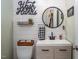 Stylish half bath features a vanity with modern fixtures, shiplap wall, and decorative accents at 711 Kentcie Ln, Efland, NC 27243