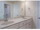 Bathroom with double sinks, white cabinets, white door, marble countertop and white walls at 711 Kentcie Ln, Efland, NC 27243
