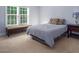 Bedroom with large window, carpet floor, bed and cushioned seat and dark wooden furniture at 711 Kentcie Ln, Efland, NC 27243