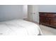Bedroom with carpet floor, bed with white linens, light blue walls, and dark brown dresser at 711 Kentcie Ln, Efland, NC 27243