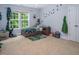 Bright bedroom with a daybed and toys, featuring a carpet floor, large window and toys at 711 Kentcie Ln, Efland, NC 27243