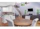 Open view of the kitchen, dining, and living area featuring a staircase with iron railing at 711 Kentcie Ln, Efland, NC 27243