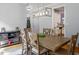 Well-lit dining room with an ornamental light fixture, space for six chairs, and hardwood floors at 711 Kentcie Ln, Efland, NC 27243