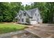 Charming two-story home with well-manicured lawn, attached garage, and classic gray siding at 711 Kentcie Ln, Efland, NC 27243
