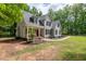 Inviting home exterior with covered front porch, well-maintained lawn, and classic design elements at 711 Kentcie Ln, Efland, NC 27243