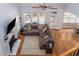 Open view of the living room with fireplace, hardwood floors, and seamless flow to dining area at 711 Kentcie Ln, Efland, NC 27243