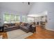 Open-concept living area with hardwood floors, connecting to the dining area and kitchen at 711 Kentcie Ln, Efland, NC 27243