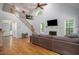 Open floor plan showcasing a vaulted ceiling, staircase, and a cozy living area with a fireplace at 711 Kentcie Ln, Efland, NC 27243