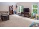 Spacious living room with sofa, carpet floor, TV and large windows at 711 Kentcie Ln, Efland, NC 27243