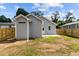 View of the home's backyard featuring a newly installed privacy fence and small cement patio at 815 Goshen St, Oxford, NC 27565