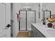 Well-lit bathroom features a dual sink vanity, a modern shower with glass doors, and updated fixtures at 815 Goshen St, Oxford, NC 27565