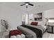 Bright bedroom features a ceiling fan, large windows and an attached bathroom with gray cabinets at 815 Goshen St, Oxford, NC 27565