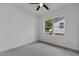 Bright bedroom featuring neutral carpet, ceiling fan, and a window overlooking the outdoors at 815 Goshen St, Oxford, NC 27565