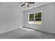Bright bedroom featuring neutral carpet, ceiling fan, and a window overlooking the outdoors at 815 Goshen St, Oxford, NC 27565