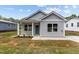 Charming single-story home with gray siding, covered entry, and manicured landscaping at 815 Goshen St, Oxford, NC 27565
