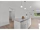 Well-lit kitchen island with white cabinets and granite countertop, perfect for food preparation at 815 Goshen St, Oxford, NC 27565