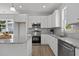 Modern kitchen with white cabinets, granite countertops, and stainless steel appliances at 815 Goshen St, Oxford, NC 27565