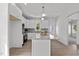 Modern kitchen features white cabinets, granite countertops, stainless appliances, and island at 815 Goshen St, Oxford, NC 27565