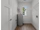 This laundry room includes shelving, a washer/dryer hookup, and a tank water heater at 815 Goshen St, Oxford, NC 27565