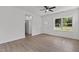 Light-filled living room with hardwood floors, ceiling fan, and large windows create a welcoming space at 815 Goshen St, Oxford, NC 27565