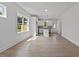 Spacious living room with light hardwood floors, offering ample natural light and a view of the modern kitchen at 815 Goshen St, Oxford, NC 27565