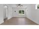 Bright living room with hardwood floors, ceiling fan, and large windows offers a welcoming space at 815 Goshen St, Oxford, NC 27565