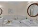 The bright bathroom has a soaking tub, white cabinets, a large mirror, and vanity at 8325 Wycombe Ln, Raleigh, NC 27615
