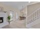Dining area featuring lots of light, a fireplace, and stairs at 8325 Wycombe Ln, Raleigh, NC 27615