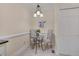 Charming dining area features a round glass table with seating for two and an elegant chandelier at 8325 Wycombe Ln, Raleigh, NC 27615