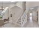 Bright entryway featuring a staircase, dining area, and doorway to the kitchen at 8325 Wycombe Ln, Raleigh, NC 27615