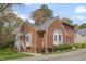 Beautiful brick townhome featuring manicured landscaping and charming architectural details at 8325 Wycombe Ln, Raleigh, NC 27615