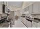 Galley kitchen with tile backsplash, and stainless appliances, offering seamless cooking experience at 8325 Wycombe Ln, Raleigh, NC 27615