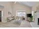 Cozy living room featuring a fireplace, light walls, and lots of natural light at 8325 Wycombe Ln, Raleigh, NC 27615