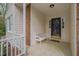 Inviting front porch with neutral siding, brick accents, and a cozy bench at 8325 Wycombe Ln, Raleigh, NC 27615