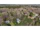 Aerial view of a property surrounded by lush greenery and mature trees, showcasing privacy and natural beauty at 85 Rolling Cloud Dr, Louisburg, NC 27549