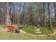 Enjoy the tranquil backyard with a pond, bench, and lush greenery, perfect for relaxation and outdoor enjoyment at 85 Rolling Cloud Dr, Louisburg, NC 27549
