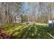 Large backyard featuring a shed, a fire pit with chairs, and plenty of green space for outdoor activities at 85 Rolling Cloud Dr, Louisburg, NC 27549