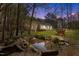 Serene backyard featuring a tranquil pond, landscaping, and a peaceful outdoor seating area at 85 Rolling Cloud Dr, Louisburg, NC 27549