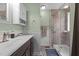 Well-lit bathroom features a vanity with storage and a glass-enclosed shower, creating a clean and inviting space at 85 Rolling Cloud Dr, Louisburg, NC 27549