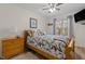 Comfortable bedroom with a ceiling fan, a wooden sleigh bed and a large window providing natural light at 85 Rolling Cloud Dr, Louisburg, NC 27549