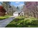 Attractive single-Gathering home featuring a well-manicured lawn, mature trees, and an attached garage at 85 Rolling Cloud Dr, Louisburg, NC 27549