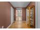 Hallway features hardwood floors, neutral walls, and a built-in display case, leading to other rooms at 85 Rolling Cloud Dr, Louisburg, NC 27549