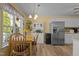 Eat-in kitchen features a wood dining table set with stainless steel appliances and ample natural light at 85 Rolling Cloud Dr, Louisburg, NC 27549