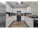 Well-lit kitchen featuring ample counter space, modern appliances, and stylish backsplash at 85 Rolling Cloud Dr, Louisburg, NC 27549
