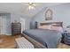 Spacious main bedroom with high ceilings, a large bed, and an ensuite bathroom entrance at 85 Rolling Cloud Dr, Louisburg, NC 27549