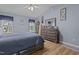 Bright main bedroom with hardwood floors, a large dresser, and ample natural light from windows at 85 Rolling Cloud Dr, Louisburg, NC 27549