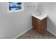 Bathroom featuring a wooden vanity with sink and a window view of the neighborhood at 932 Mailwood Dr, Knightdale, NC 27545
