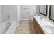 Clean bathroom featuring a dual sink vanity with wood cabinets and a tub/shower combination at 932 Mailwood Dr, Knightdale, NC 27545